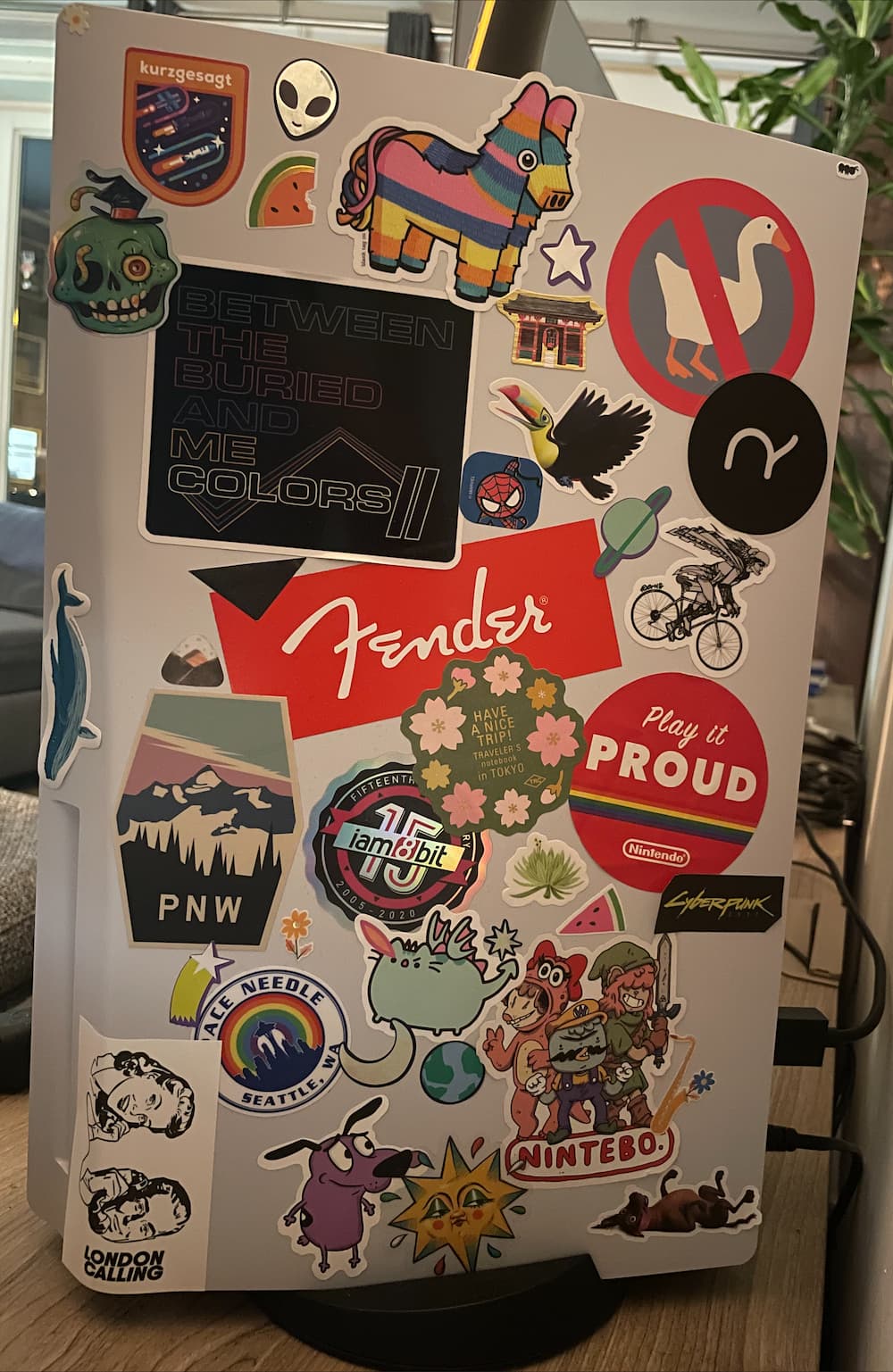 PS5 face plate with around 2 dozens of random stickers scattered over it